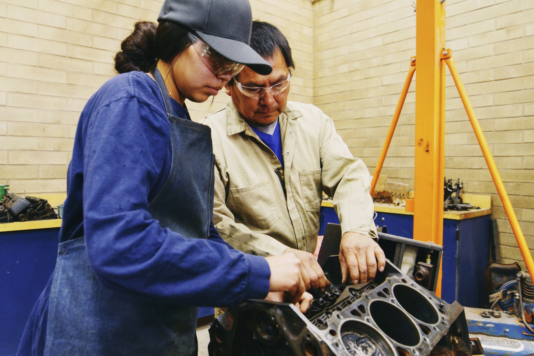 Young Woman with Teacher in an Automotive Shop