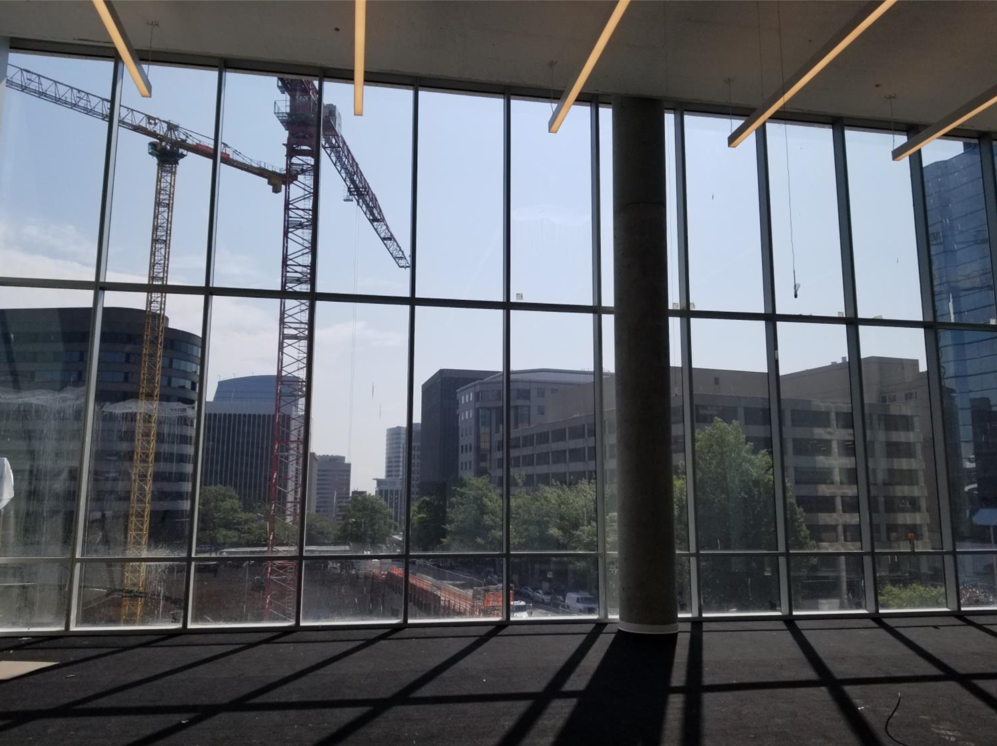 construction cranes from inside the music room of the Heights Building