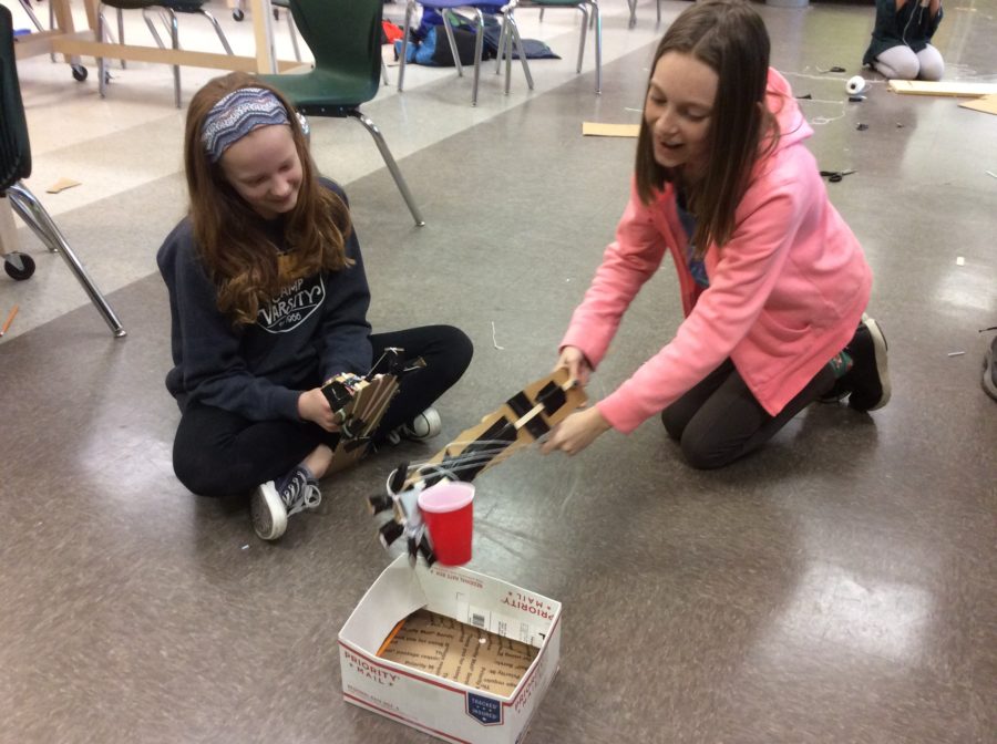 Students testing robotic arm prototype