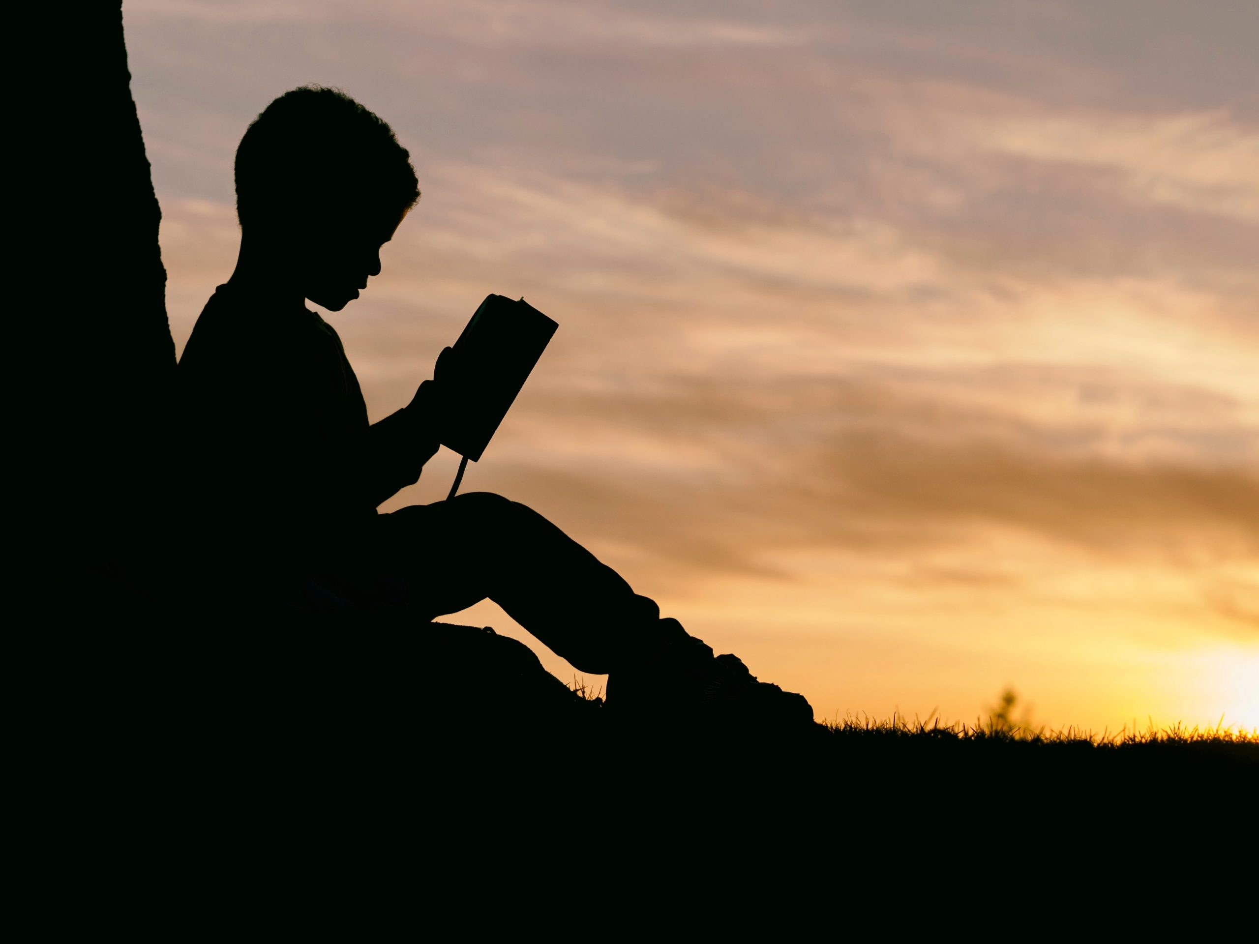 Photo of boy reading by Aaron Burden on Unsplash