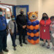 Superintendent with students and staff