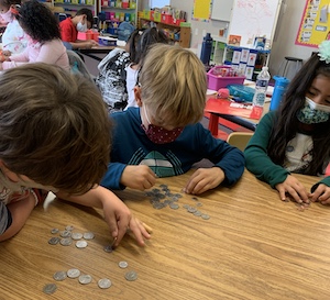 students counting coins