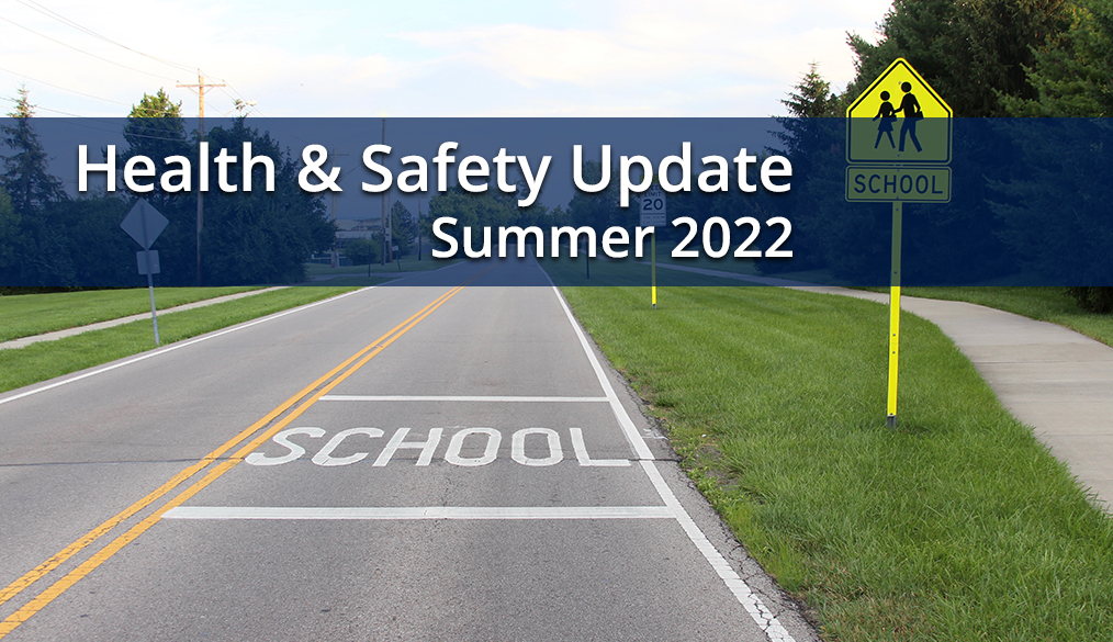 road with School painted on it and School Yield sign, with words Health & Safety Update Summer 2022