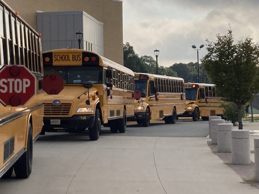 buses gathering in school parking lot on first day of school