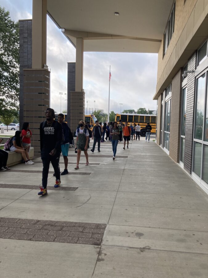 estudiantes caminando hacia el primer día de clases