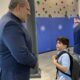 superintendent greeting student on first day of school