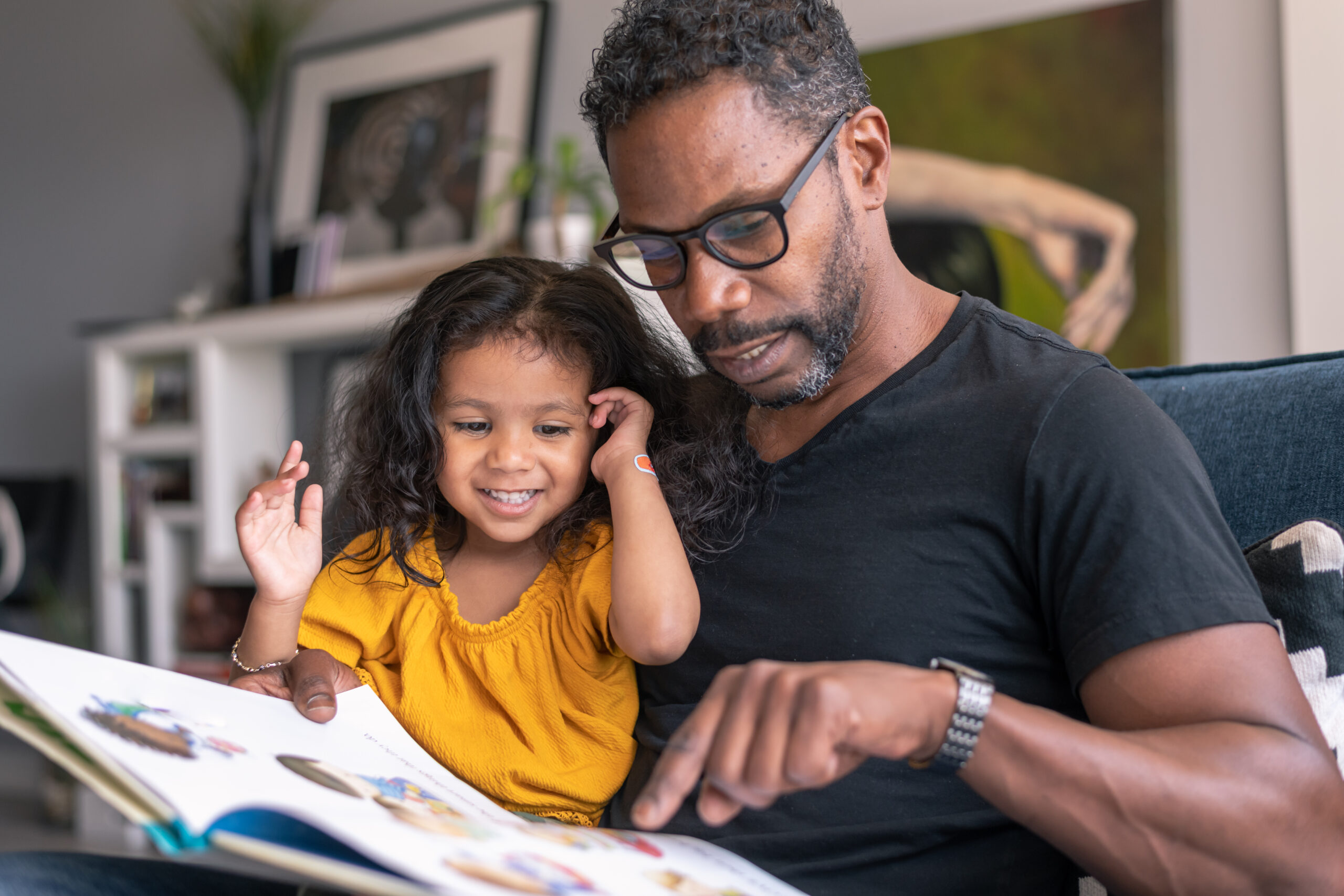 father reading book with child