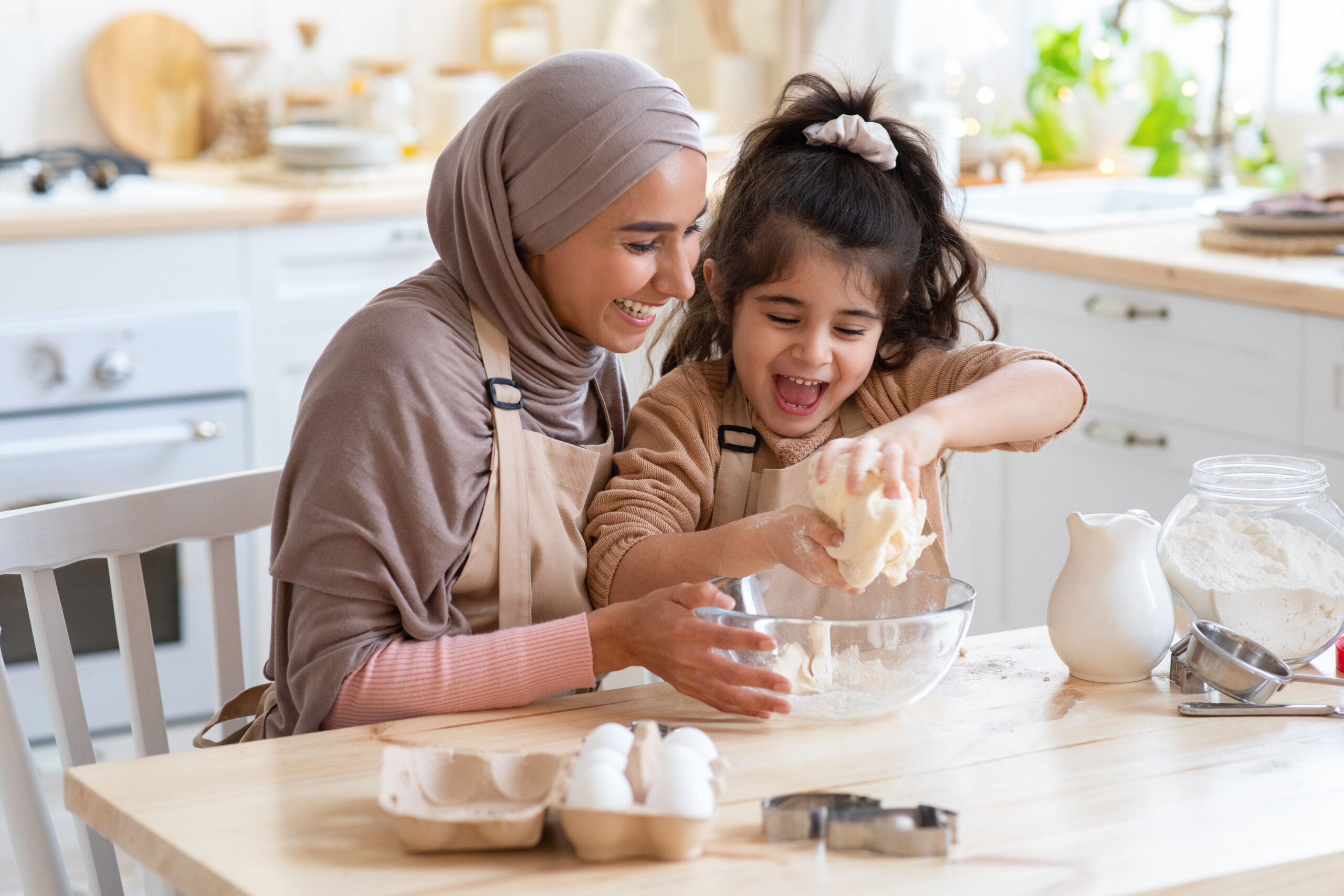 Muslim Mom And Daughter Having Fun At Home, Baking In Kitchen Together