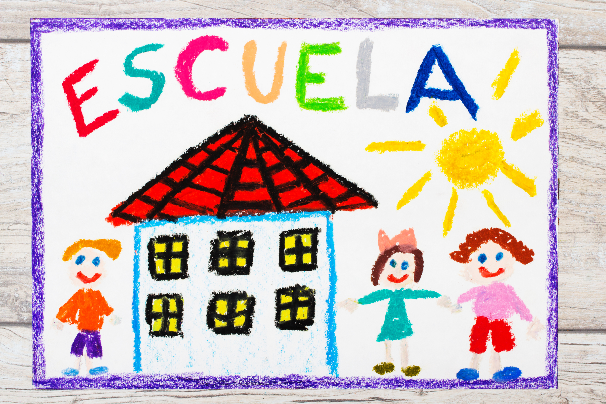 Photo of colorful drawing: Spanish word SCHOOL, school building and happy children.