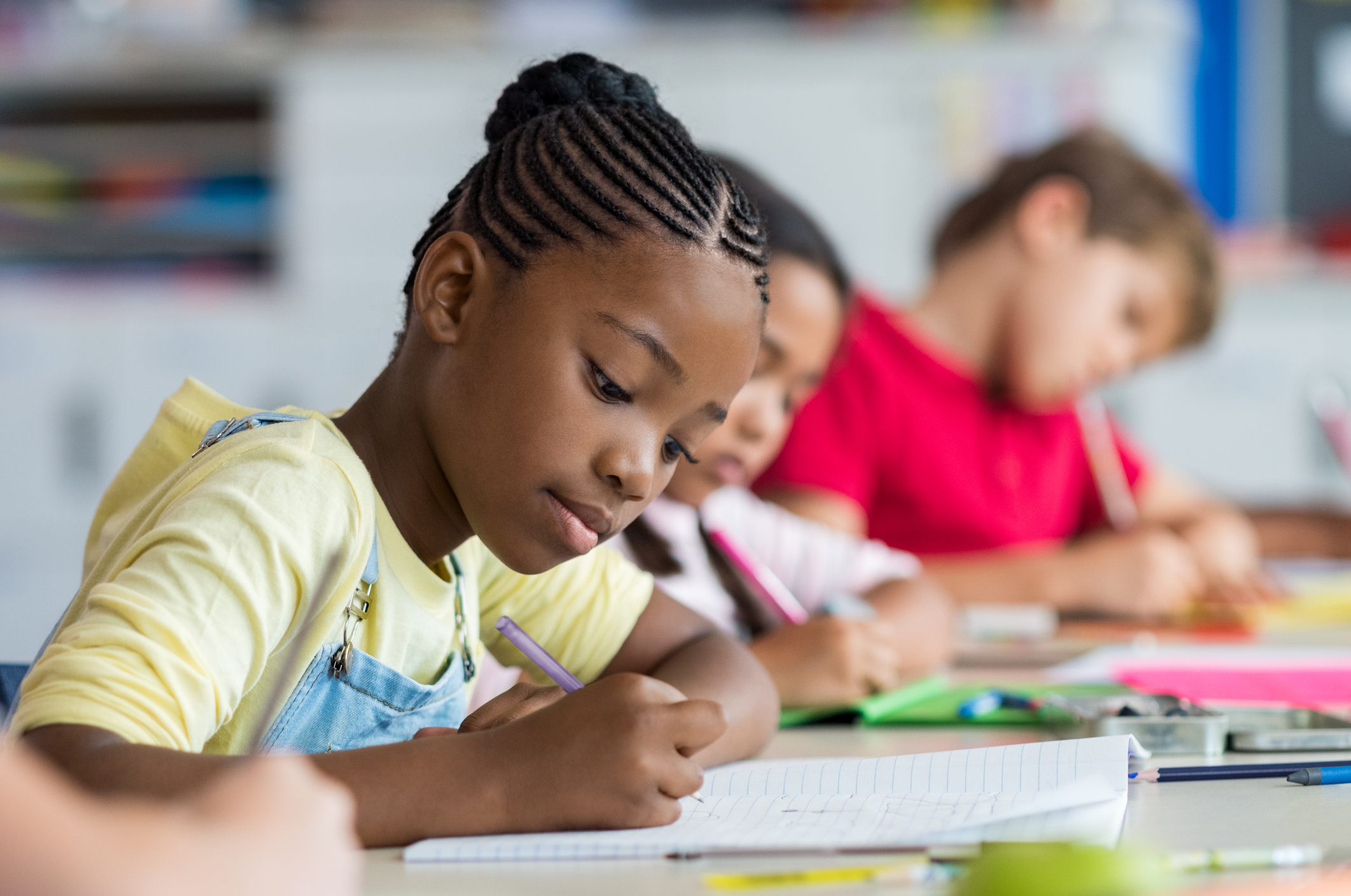 School girl writing in class