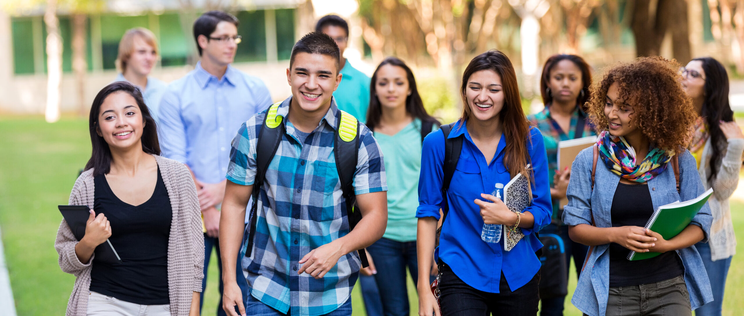 Diverse high school students walking on campus