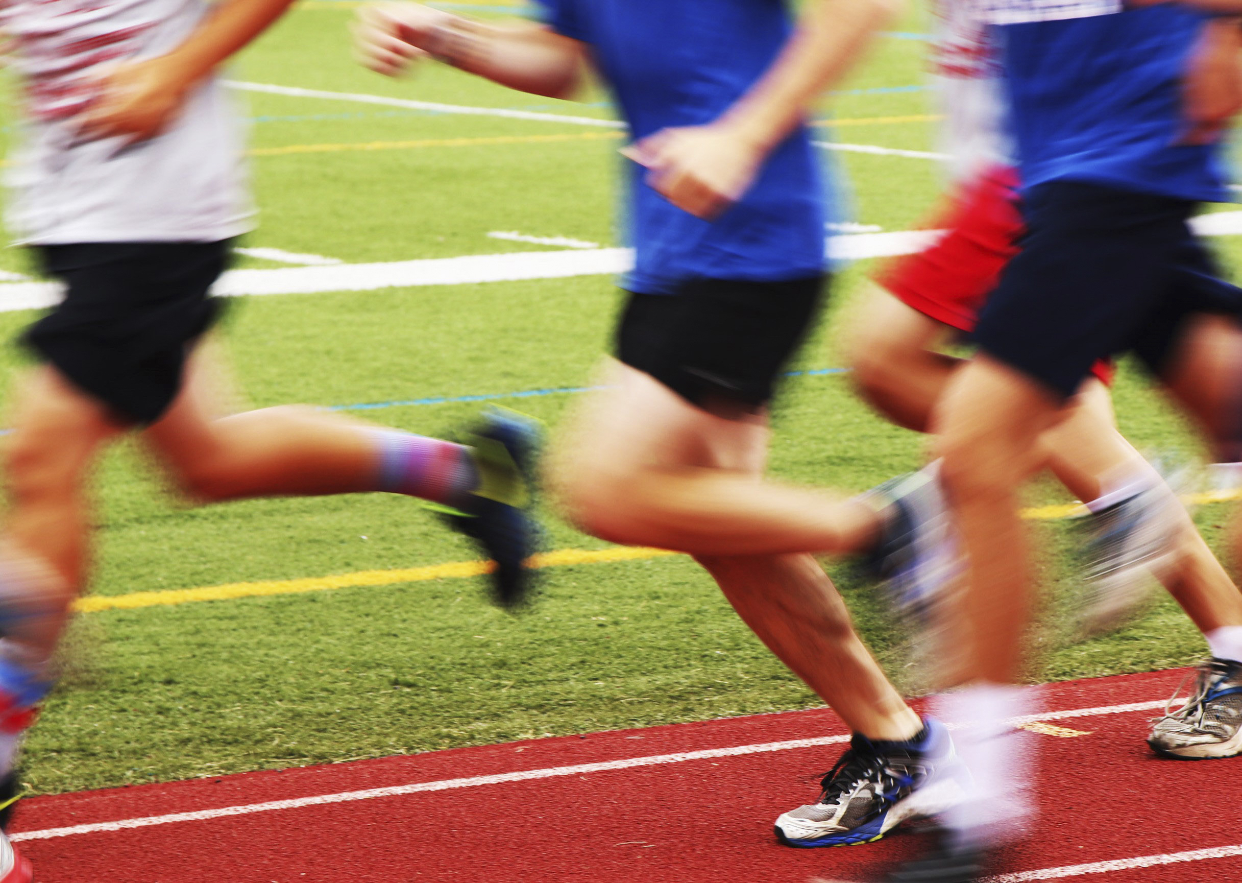 blurred runners on a track