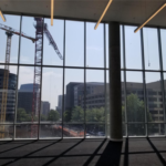 construction cranes from inside the music room of the Heights Building