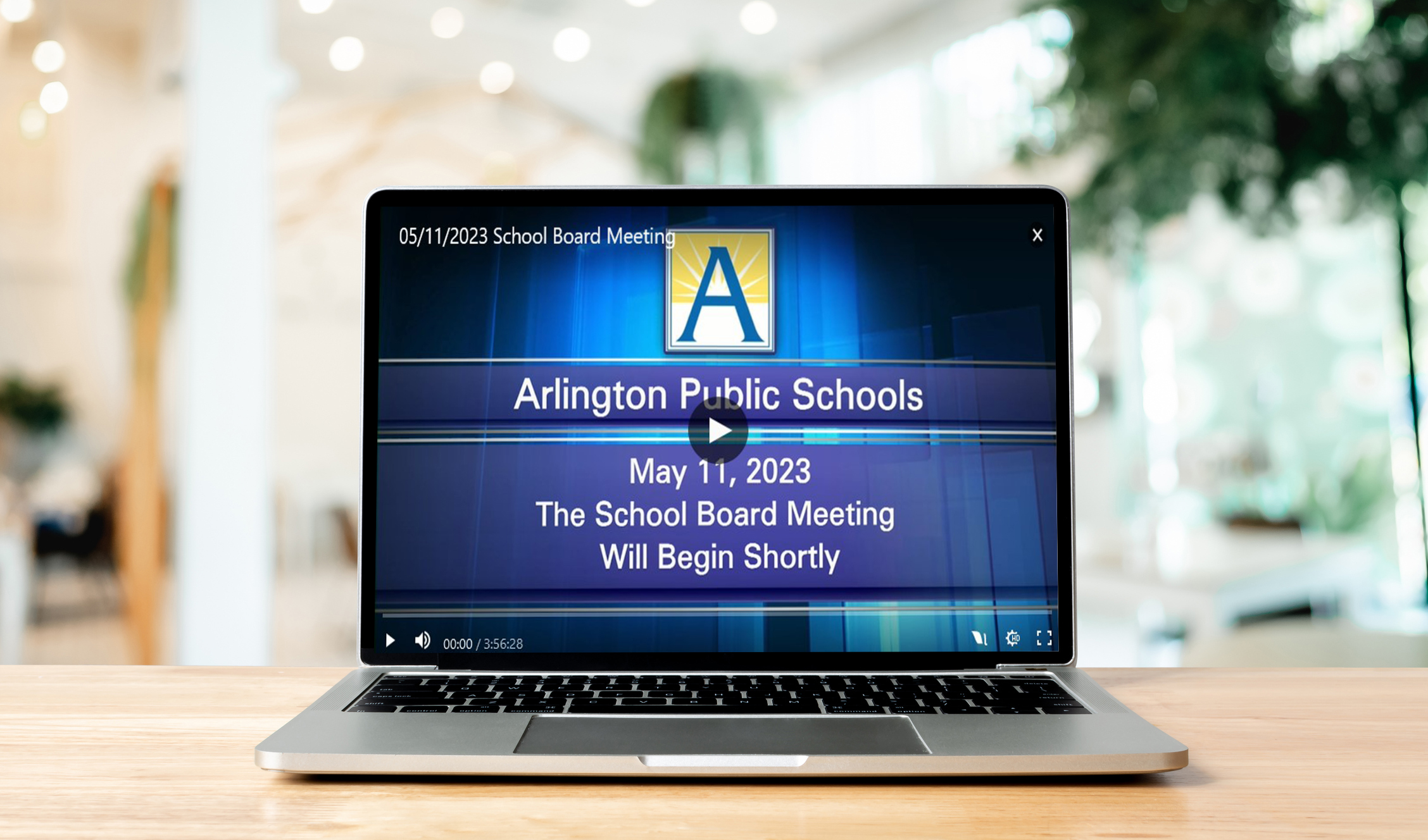 open laptop with school board meeting video