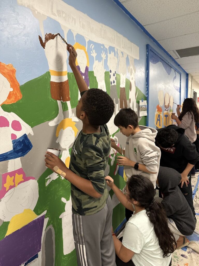 students painting a mural with Capital Murals, Jenny B