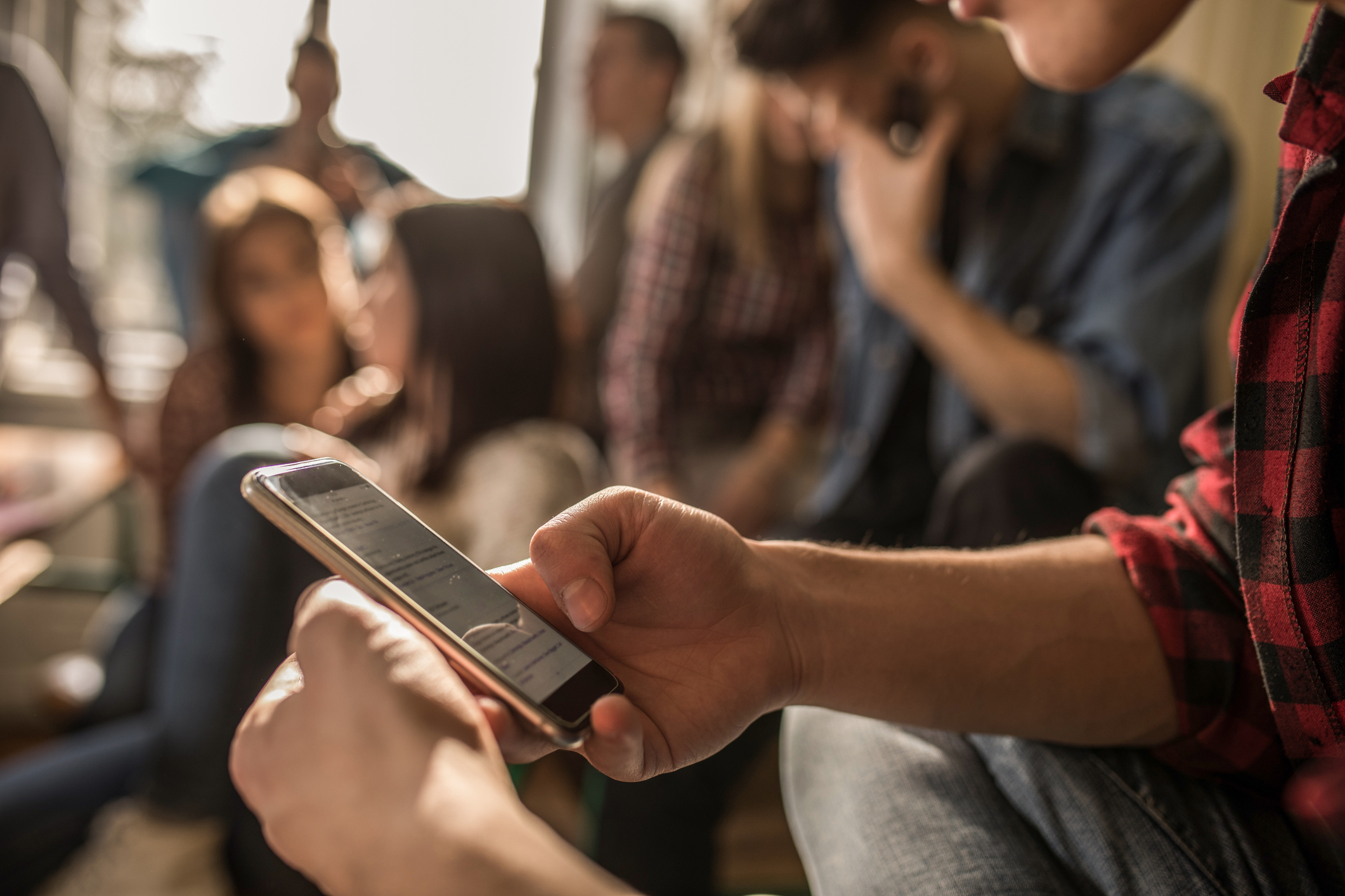 student text messaging on mobile phone