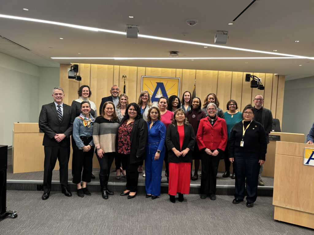 group of staff posing for photo with the school board.