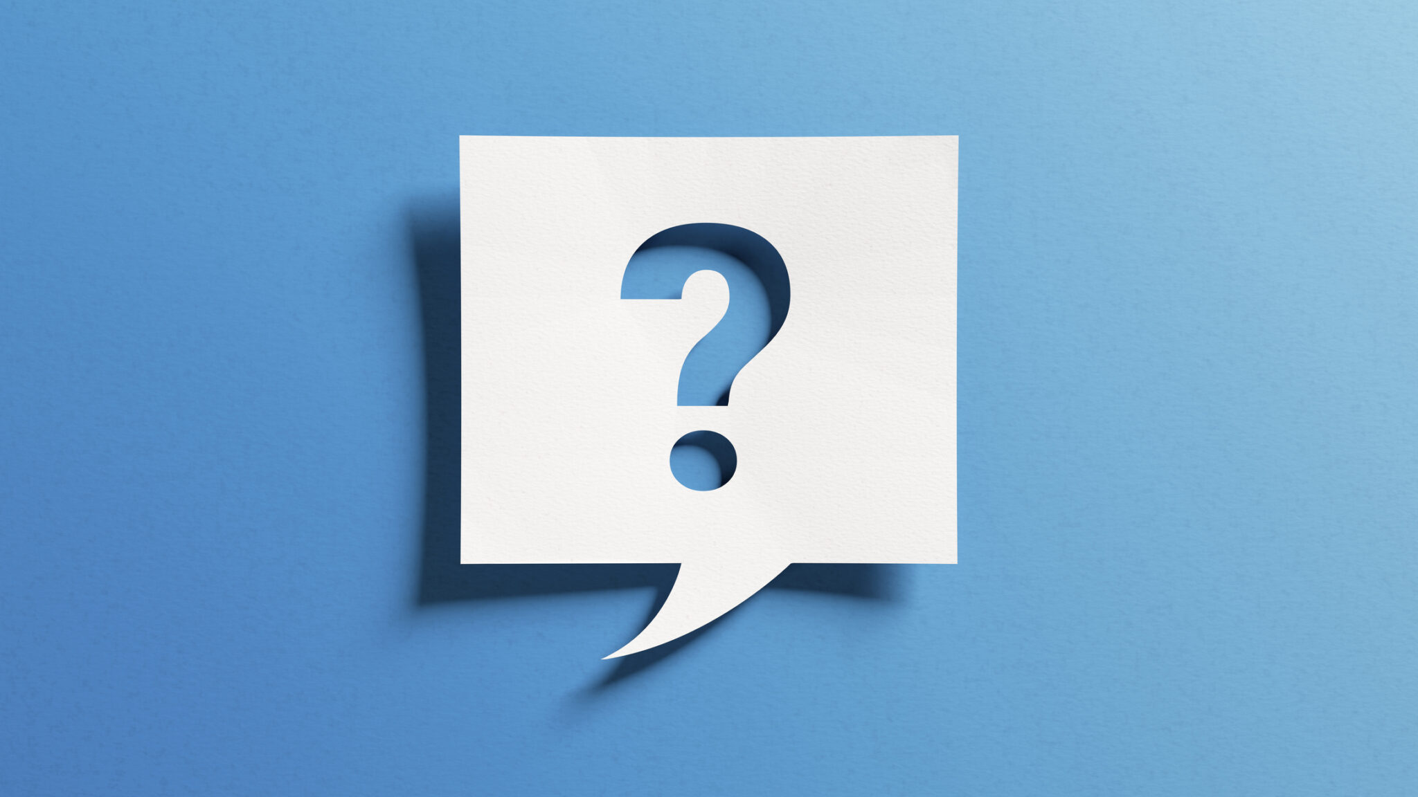 Question mark icon cutout paper and blue background.