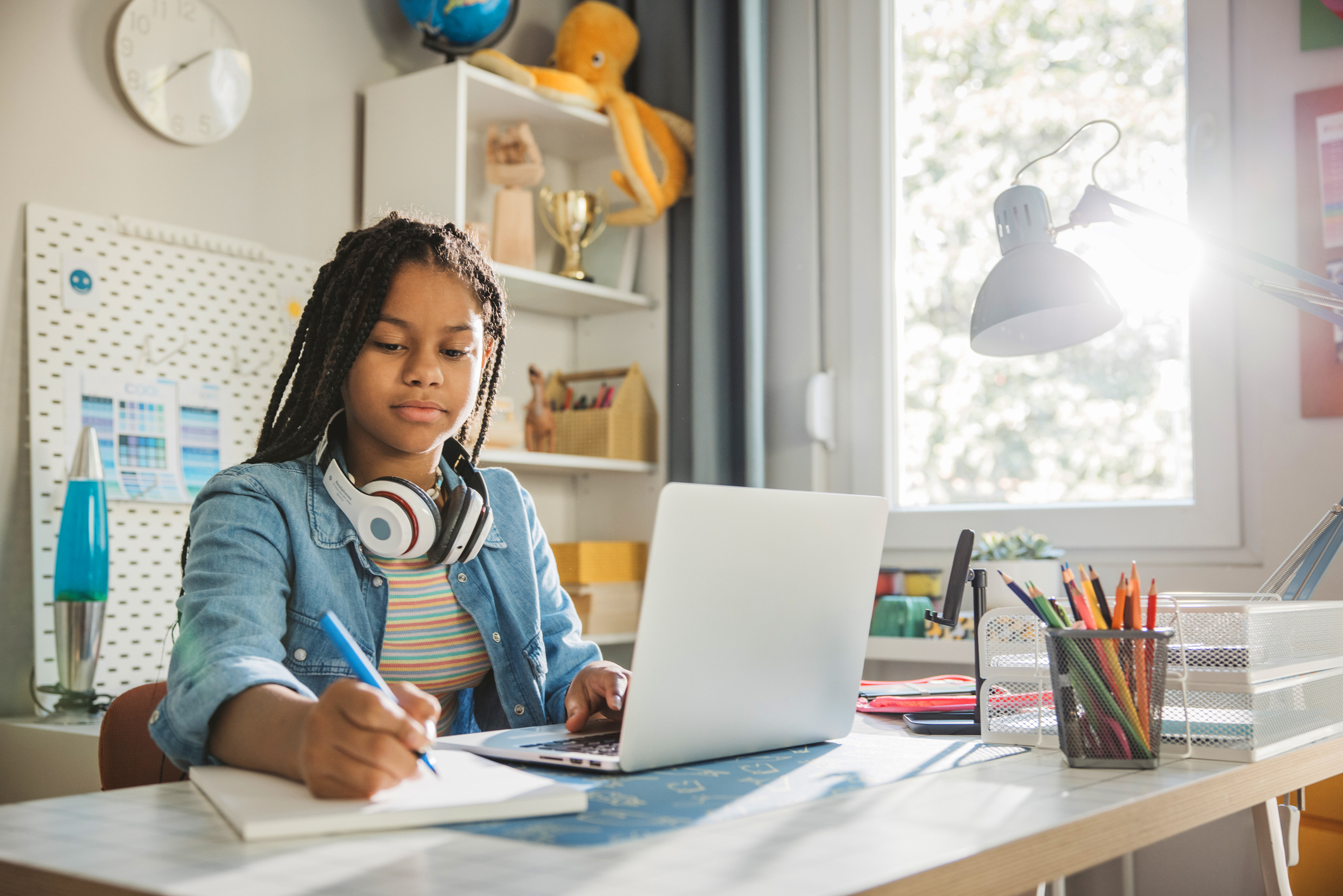 Teenage girl using laptop for homework