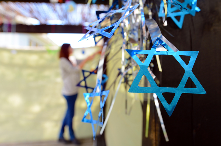 Jewish woman decorating her family Sukkah