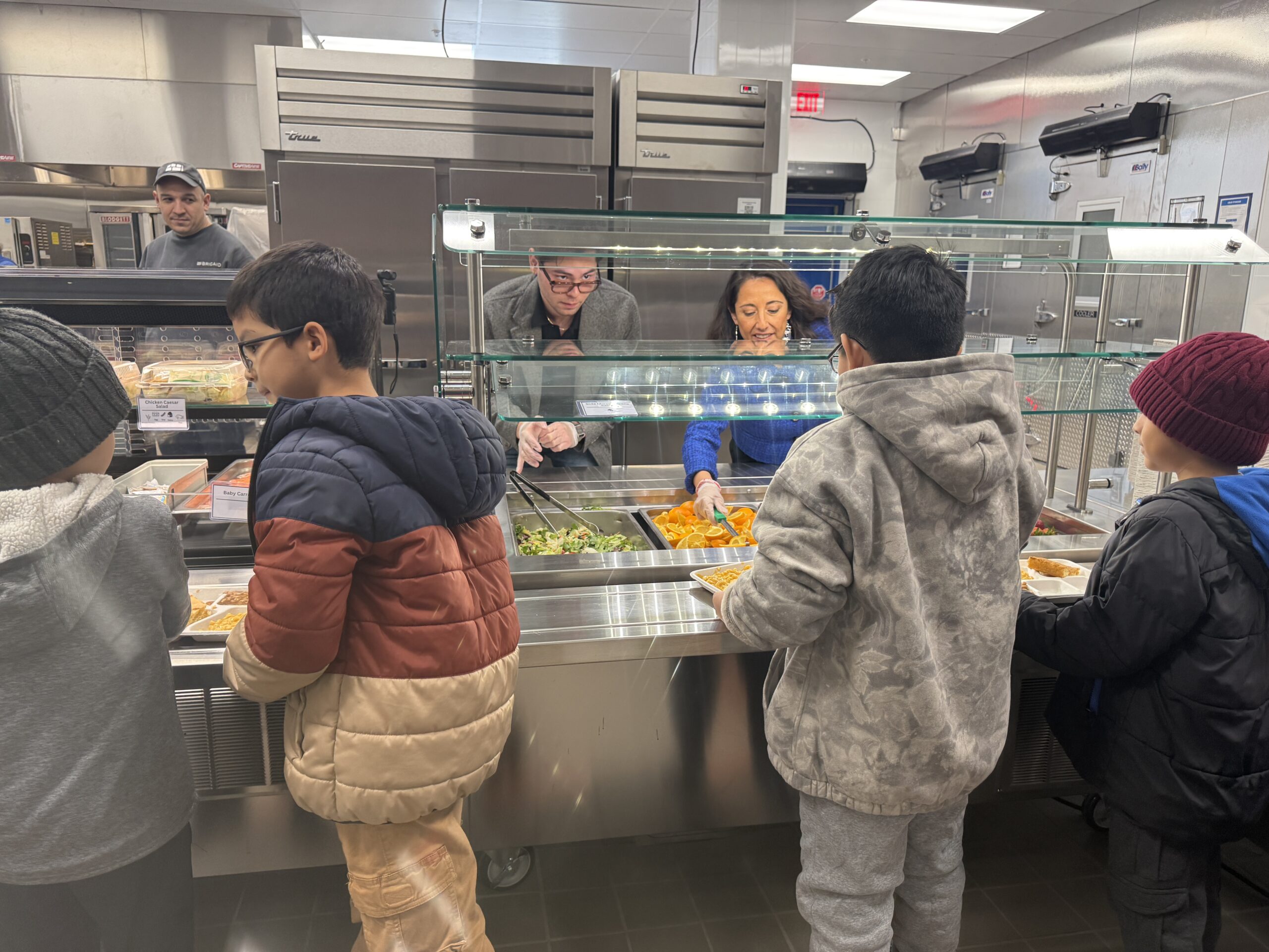 Zuraya Tapia Hedley and Jeremy Scheck serve lunch to students
