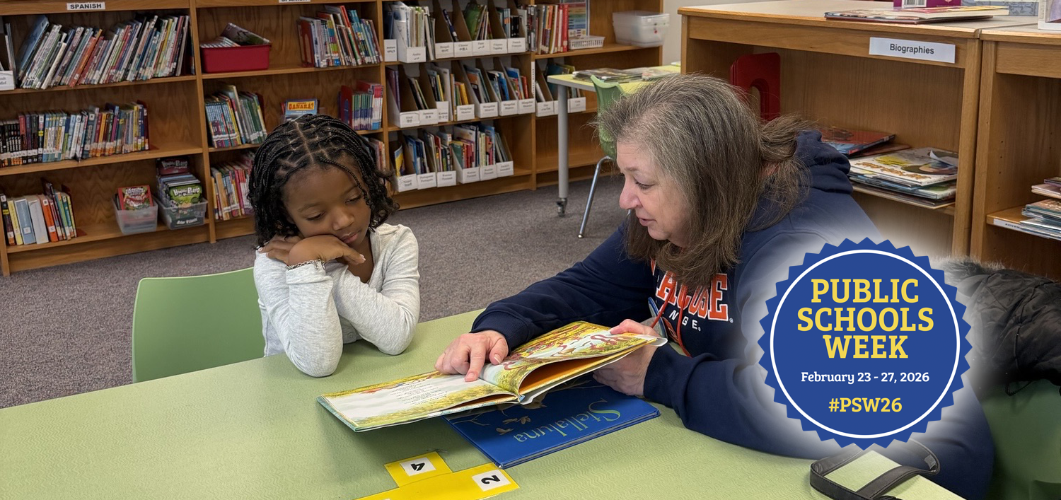 Volunteer reading to a student
