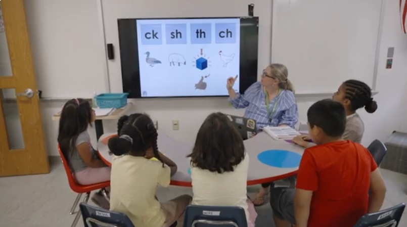 A group of students participating in a digraphs lesson with a teacher during Pathways to Progress summer program.