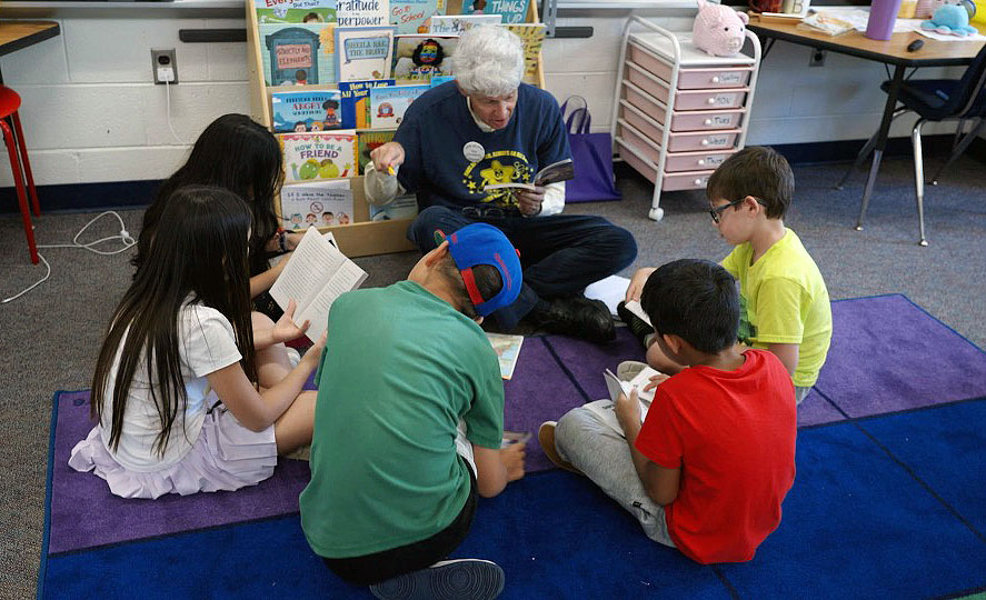 Volunteer reading to students
